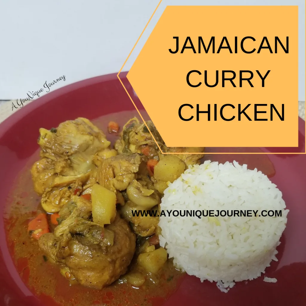 A plate with some Jamaican Curry Chicken and white rice.