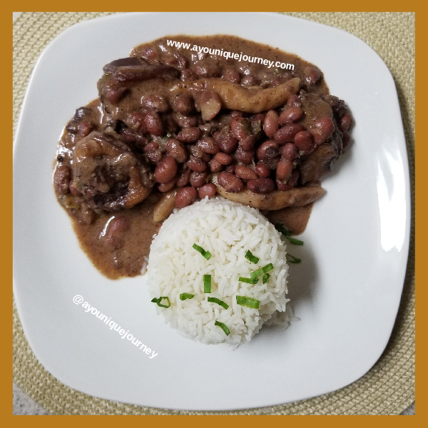 Jamaican Stew Peas served with white rice on a white plate.