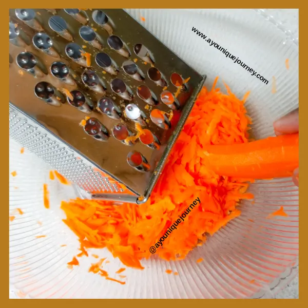 Shredding the carrots with a box grater.