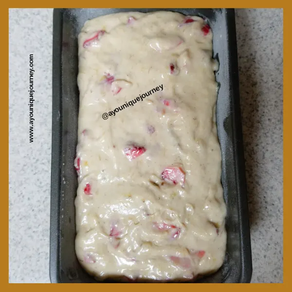 Strawberry Banana Bread batter in a loaf pan ready to bake.