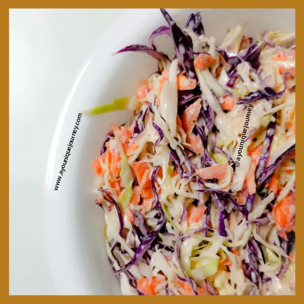 Coleslaw ready to be served in a white bowl.
