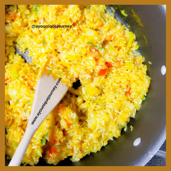 Coating the rice in the yellow mixture.