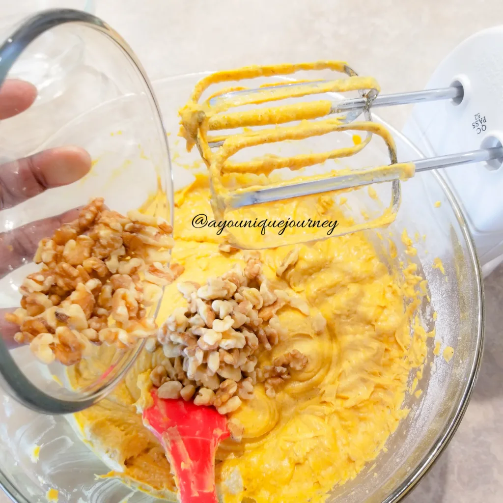 Adding chopped walnuts (if so desired) to the batter.