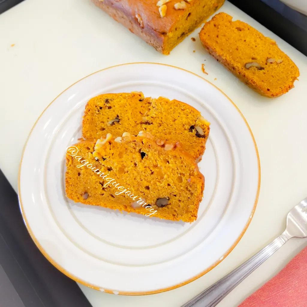 Two slices of Pumpkin Bread on a white serving plate.