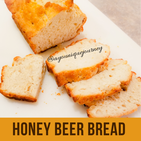 Slicing up the Honey Beer Bread on a white cutting board.