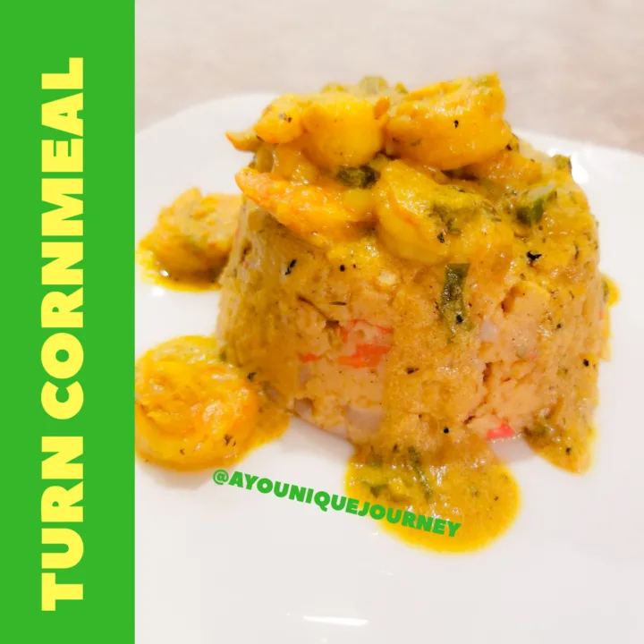 A serving of Turn Cornmeal with some Coconut Curry Shrimp on top.