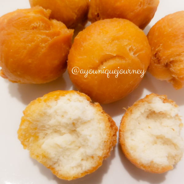 An opened Jamaican Fried Dumplings to show the soft texture inside.