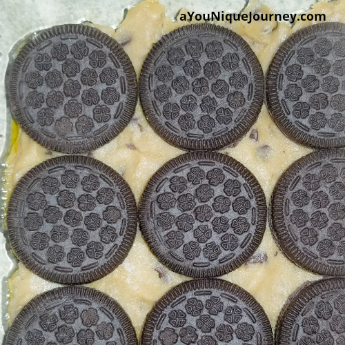 Adding the oreo sandwich cookies to the cookie dough.