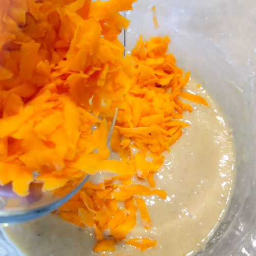 Adding the carrots to the batter.
