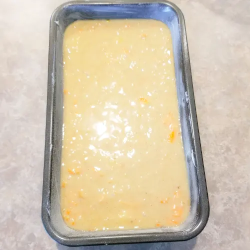 The carrot banana bread batter in the prepared loaf pan.