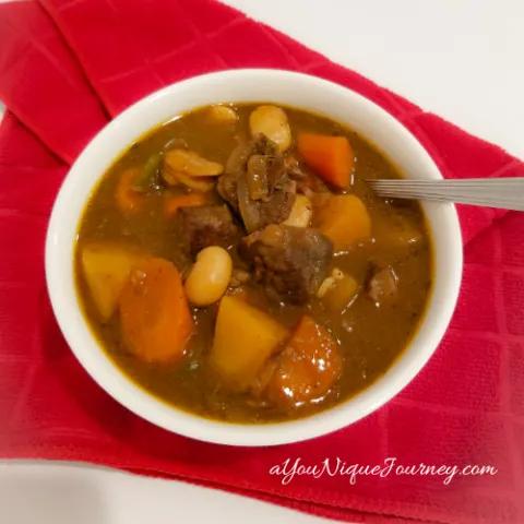 Guinness Beef Stew Recipe in a white bowl.