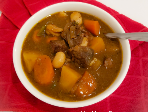 Guinness Beef Stew Recipe in a white bowl.