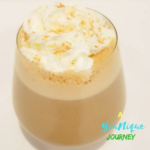 Guinness Punch with whipped cream and grated nutmeg.