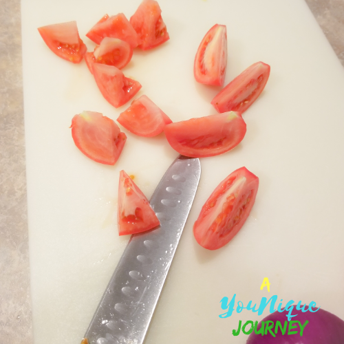 Cutting the tomatoes into wedges.