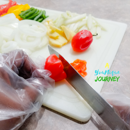 Cutting the peppers with gloves on.