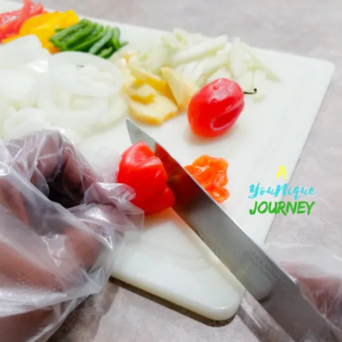 Cutting the peppers with gloves on.