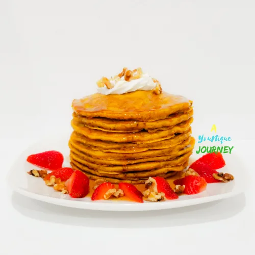 Pumpkin Pancakes with strawberry and some nuts.