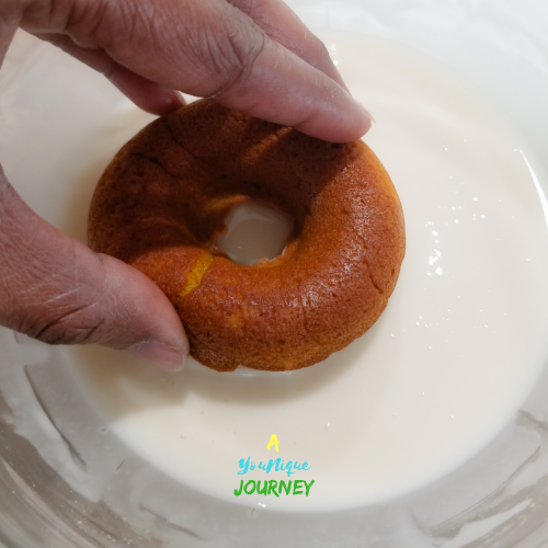 Dip the top of the donuts in the vanilla glaze.