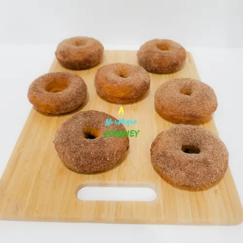 Baked Pumpkin Donuts with cinnamon sugar coating on a cutting board.