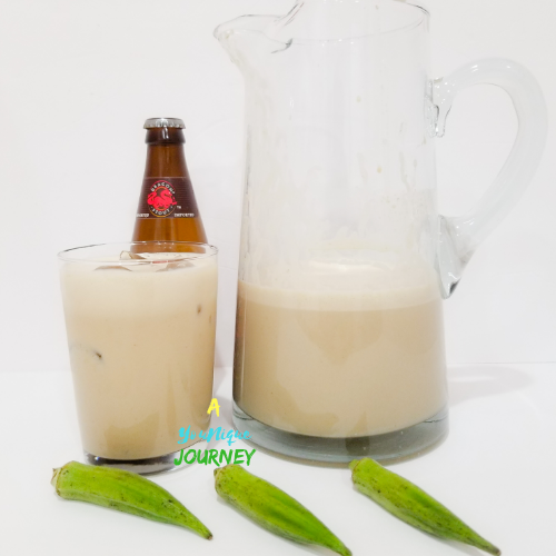 Okra Punch in both a glass and a pitcher with a bottle of dragon stout