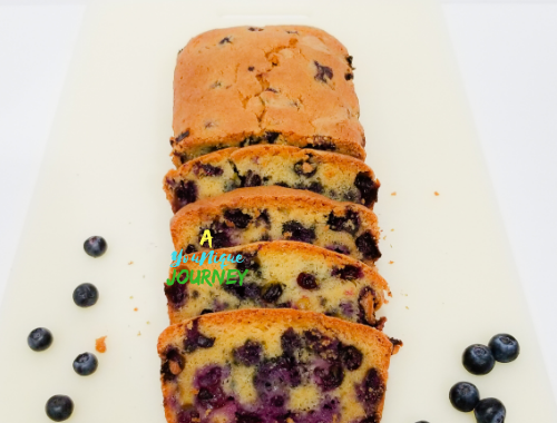 Easy Blueberry Bread Recipe on a white cutting board.
