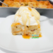 Eggnog Bread Pudding Recipe with a scoop of vanilla ice cream drizzled with rum sauce.
