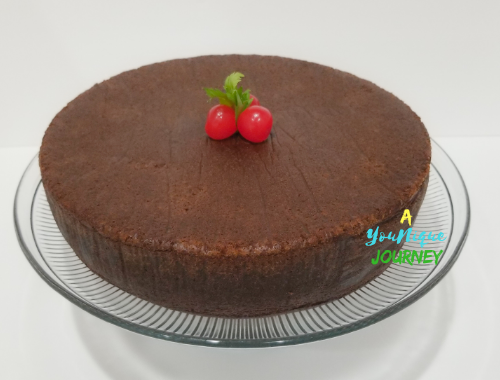 Jamaican Black Fruit Cake with cherries on the top.