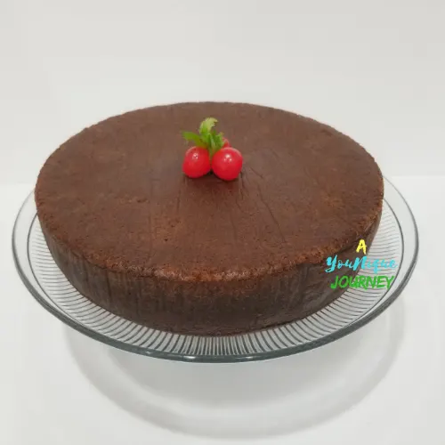 Jamaican Black Fruit Cake with cherries on the top.