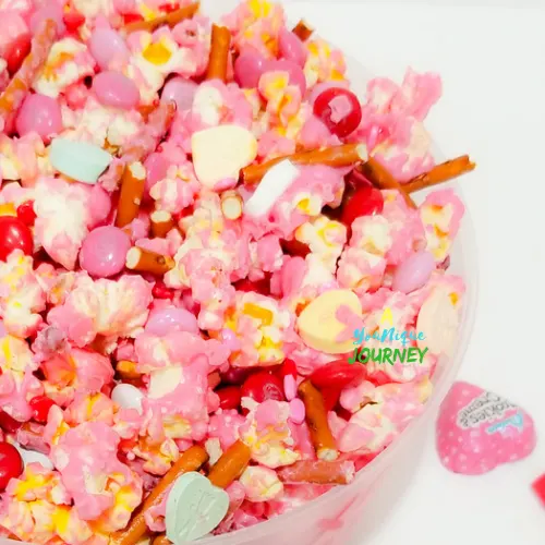 Valentine's Day Popcorn with various candies and pretzel sticks.
