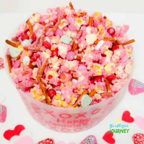 Valentine's Day Popcorn Mix in a plastic bowl.