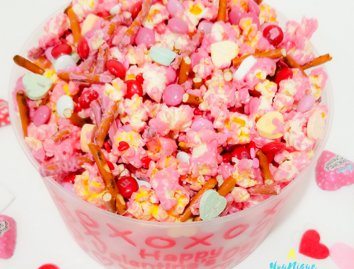 Valentine's Day Popcorn Mix in a plastic bowl.