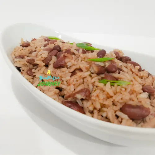 A closer look at Jamaican Rice and Peas in a white serving bowl green onion on top.