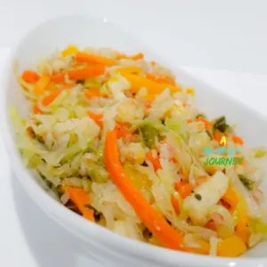 Saltfish and Cabbage Recipe in a white serving bowl.