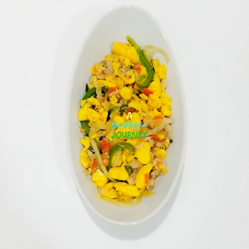 Ackee and Saltfish in a white serving bowl.