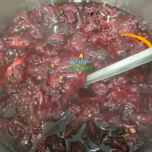 Jamaican Sorrel Drink with spices coming to a boil.