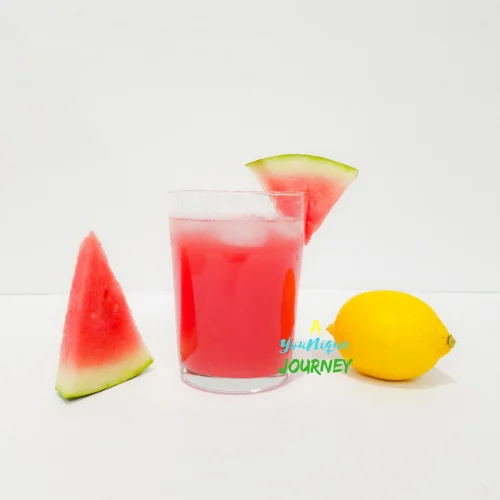 A glass of watermelon lemonade with ice cubes.