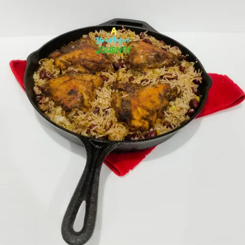 One Pot Jerk Chicken with Rice and Peas in a large cast iron skillet.