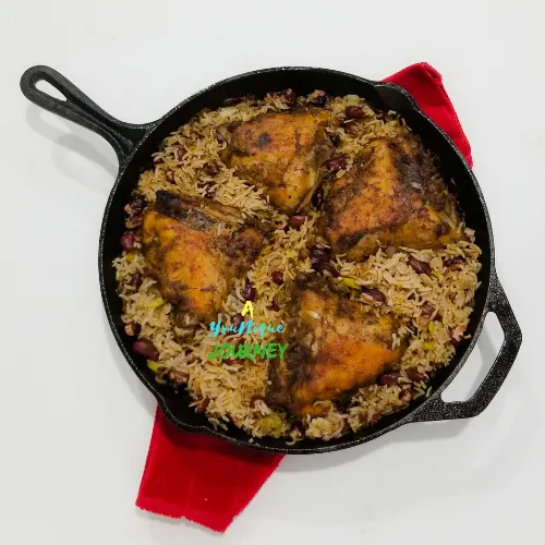 One Pot Jerk Chicken with Rice and Peas in a cast iron skillet.