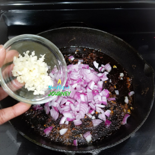 Adding the garlic to the pot.