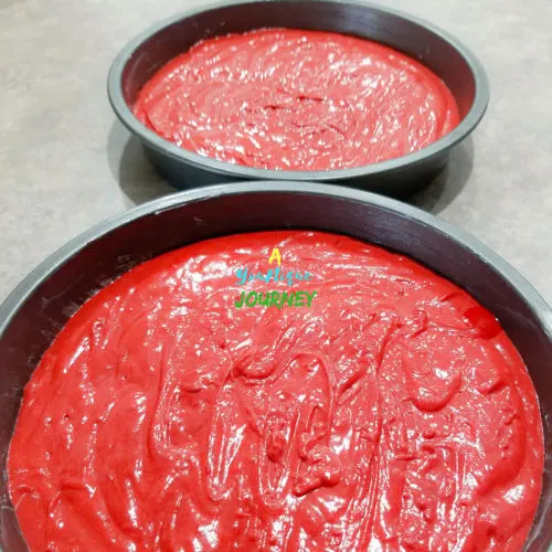 The Red Velvet Cake batter in 2 9inch baking pans.