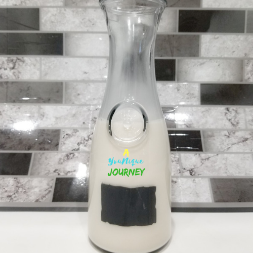 Homemade Coconut Milk Recipe in a glass pitcher.