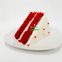 A slice of red velvet cake with cream cheese frosting.