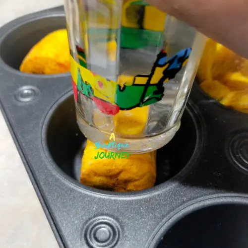 Forming the plantain cups appetizers in a muffin pan with a small glass.