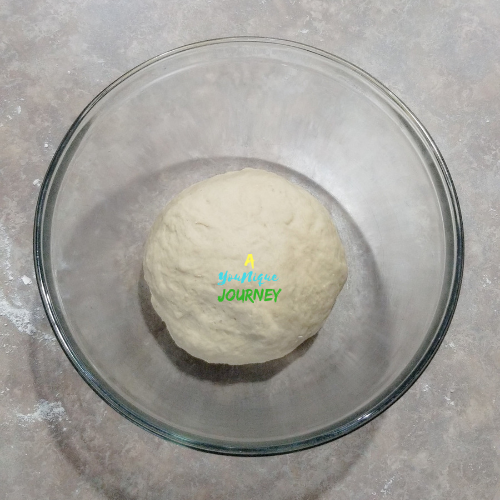 After kneading and forming the dough into a ball and covering it it a greased bowl for 1 hour.