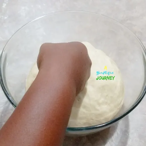 Pressing down the dough after 1 hour to deflate it.