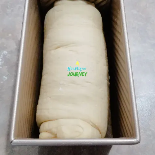 Place the rolled up (log) dough into the greased loaf pan.