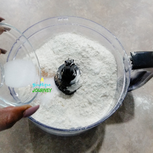 Adding the salt to the flour and nutmeg.