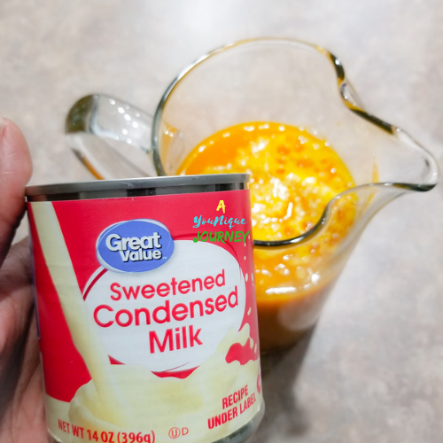Adding a can of sweetened condensed milk to sweeten the Jamaican Pumpkin Punch Recipe.