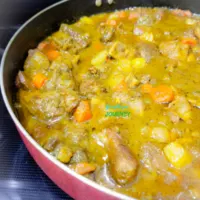 Jamaican Curry Goat in a large skillet.