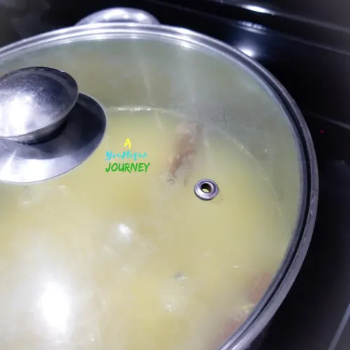Allowing the ginger mixture to come to a boil to make Jamaican Ginger Beer.